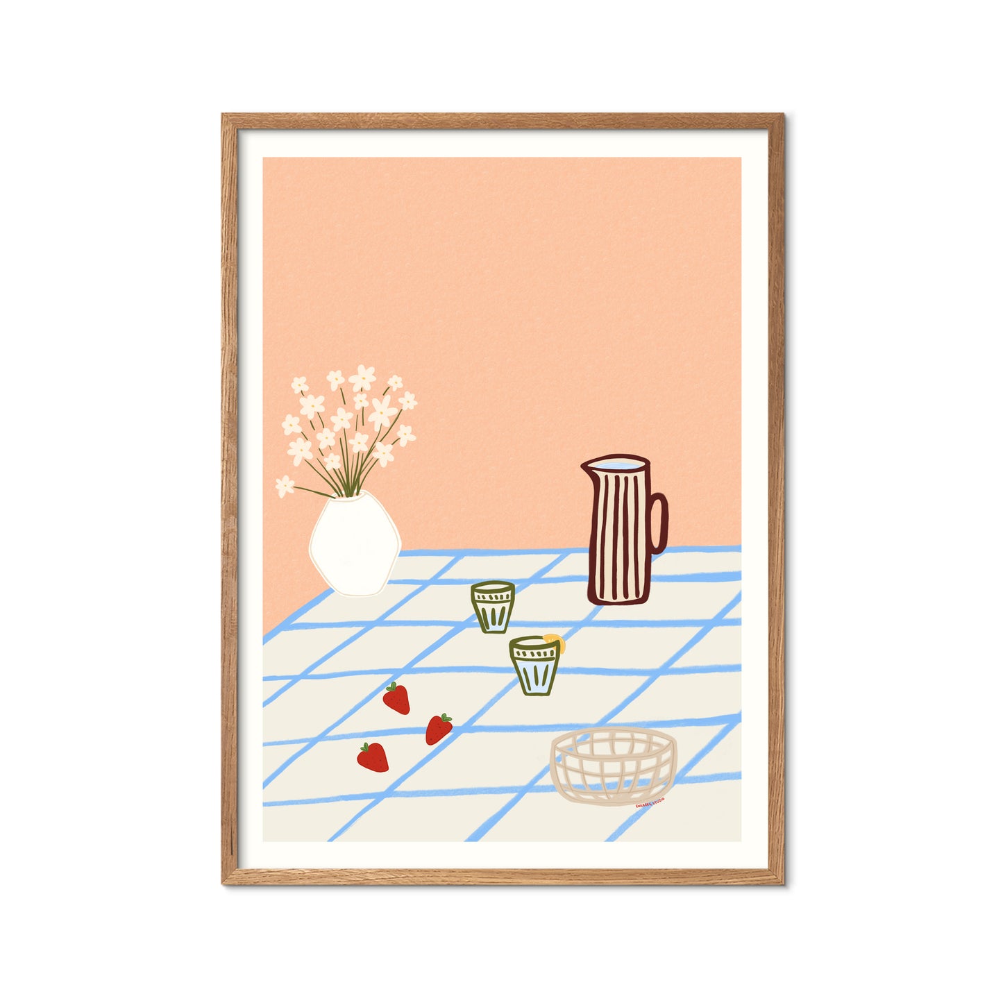 Featuring a striped pitcher, delicate flowers, two glasses, and fresh strawberries arranged on a blue-checkered tablecloth
