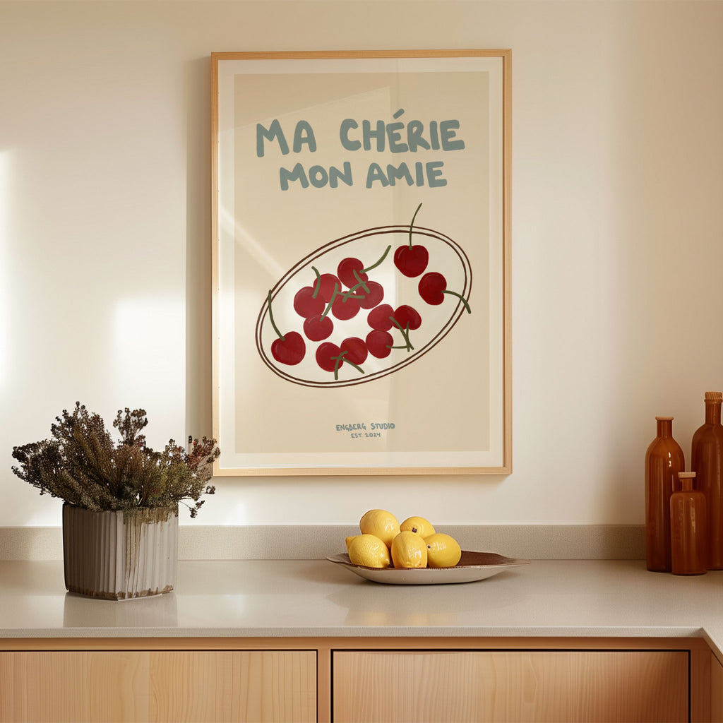 Featuring the French words “Ma Chérie, Mon Amie” in soft blue against a cream background