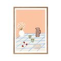 Featuring a striped pitcher, delicate flowers, two glasses, and fresh strawberries arranged on a blue-checkered tablecloth